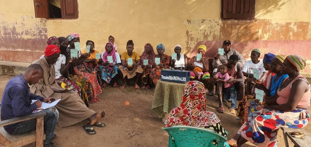 Household Saving Scheme meeting showing membership cards